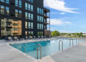 Thumbnail 4 of 53 - a swimming pool in front of a building
